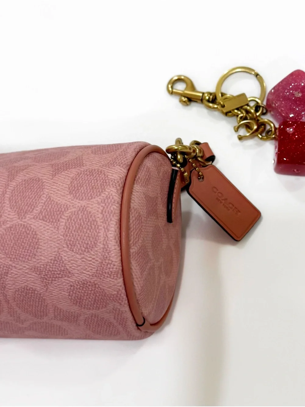 New Coach cylinder barrel bag in melon pink/ brass with signature canvas